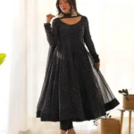 Woman wearing a black leheriya printed Anarkali kurta with matching pants and dupatta, front view ethnic festive wear suit set.