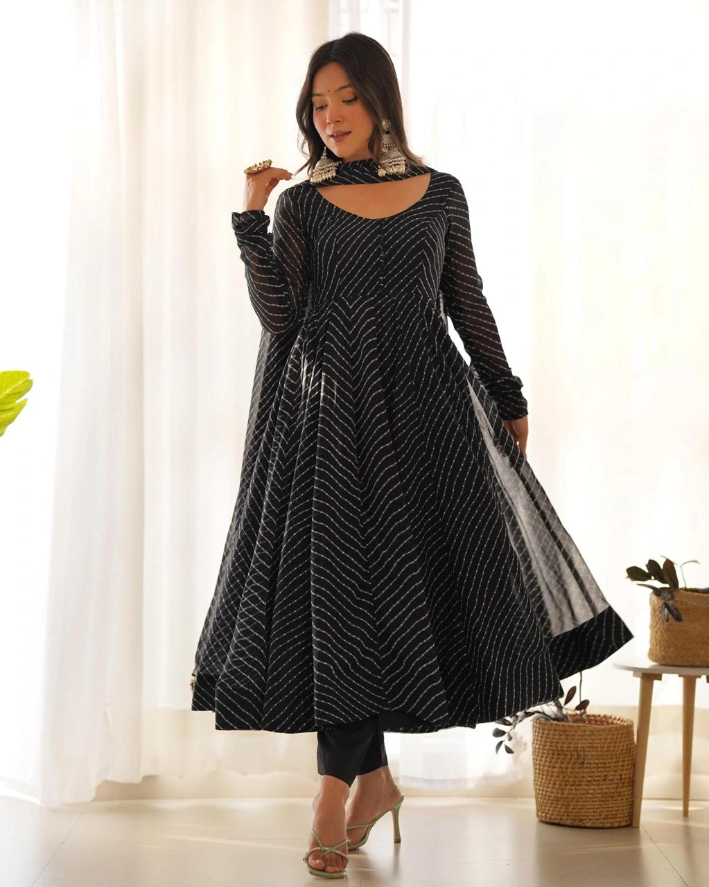 black-anarkali-suit-set-front-view Woman wearing a black leheriya printed Anarkali kurta with matching pants and dupatta, front view ethnic festive wear suit set.