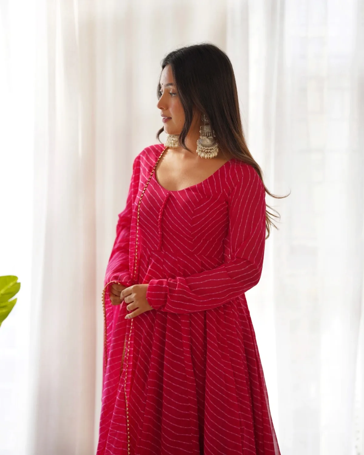 Front portrait view of women's rani pink Anarkali kurta pant dupatta set with full sleeves and festive ethnic styling.